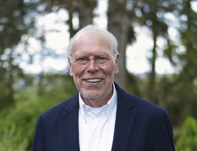 Bernd Behrens smiling outdoors amid greenery