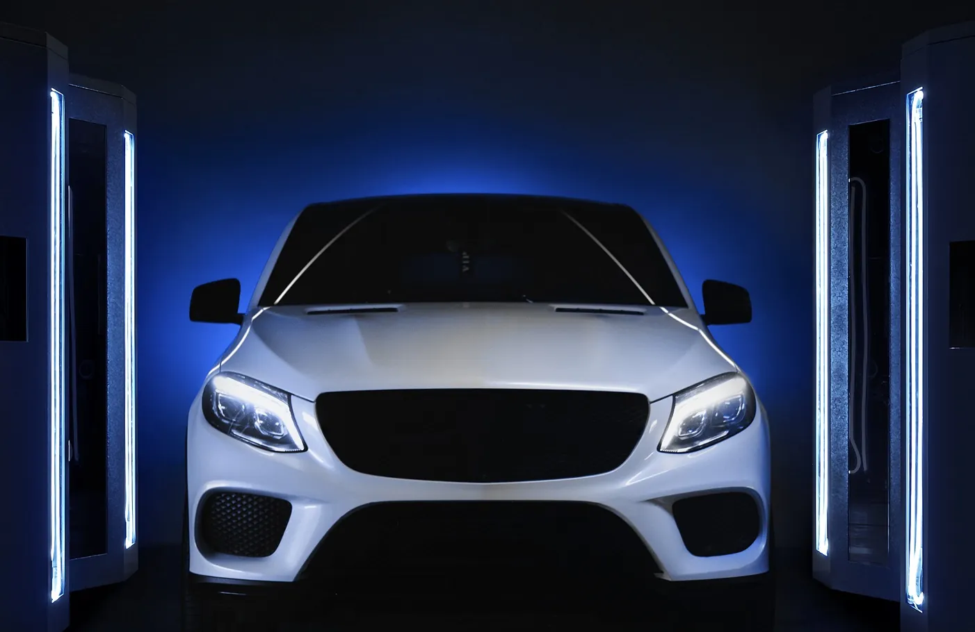 An SUV drives through the illuminated scanner gate